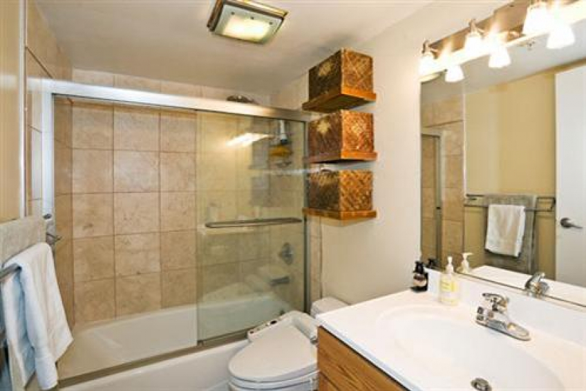 Master bath features stone tile flooring and shower, glass enclosure, bidet, and brushed stainless steel light fixtures. Resource #232458: image #15