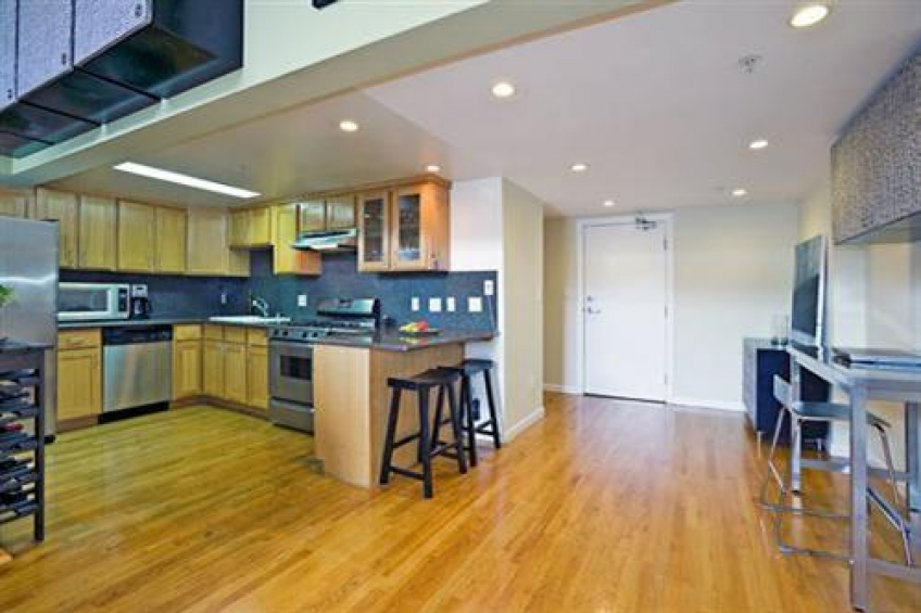 Kitchen features stainless steel appliances; granite countertops and back splash; small eat-in bar; and recessed lighting. Resource #232458: image #3