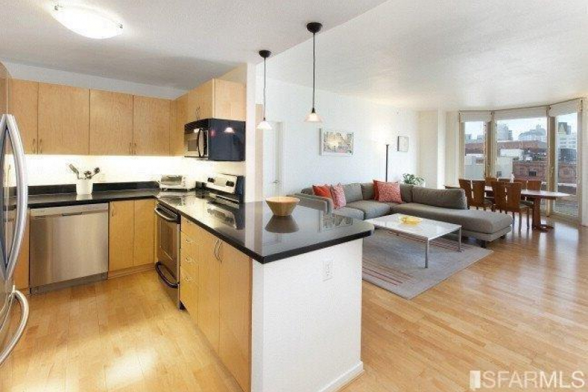 Kitchen overlooks the living area with black granite breakfast bar. Resource #289798: image #8