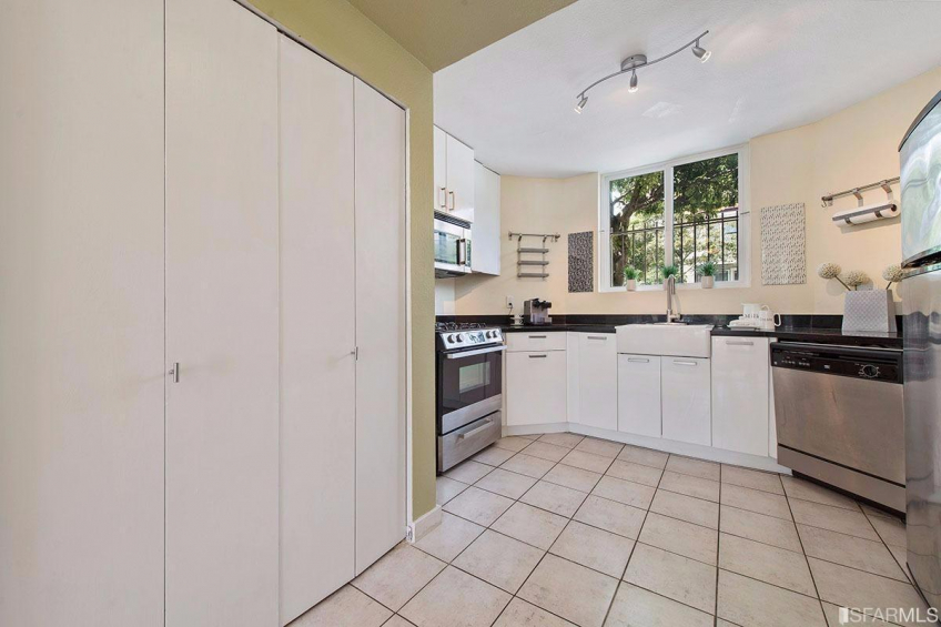 Open, updated kitchen. Behind the doors here is storage and a washer/dryer. Resource #315375: image #14