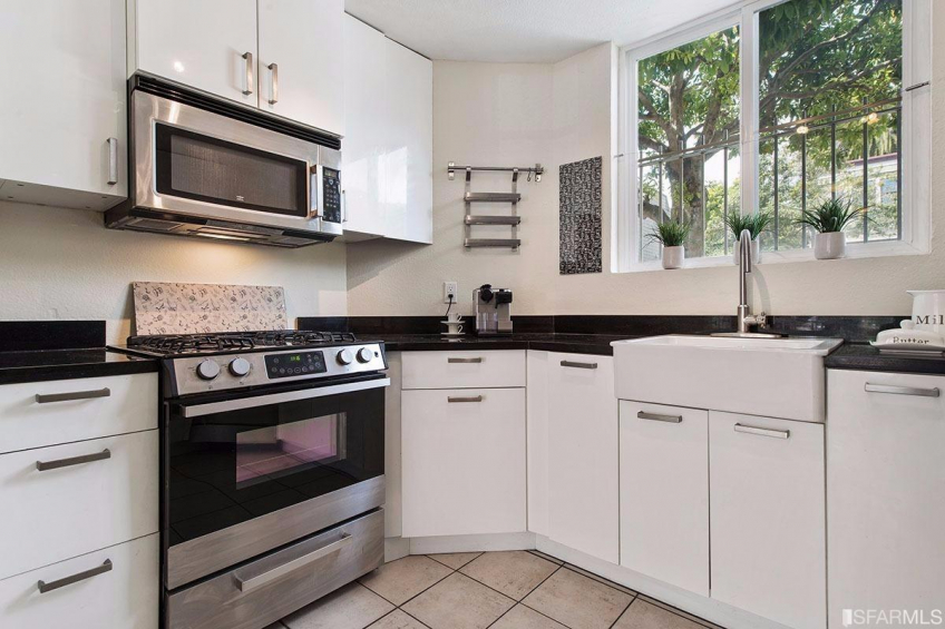 Kitchen is updated and includes built in microwave, apron front sink and ample counter/cabinet space. Resource #315375: image #17