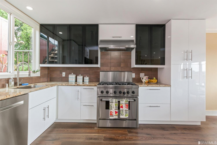 The recently remodeled top-floor kitchen features top-of-the-line appliances. Access the roof and solar panels through the kitchen window. Resource #337080: image #13