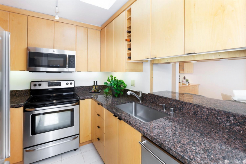 Skylight illuminates fabulous custom cabinets accommodate everything in the kitchen. Stainless appliance and granite counters with a pass through to the dining area. (yes, you can close it off). Resource #337487: image #10
